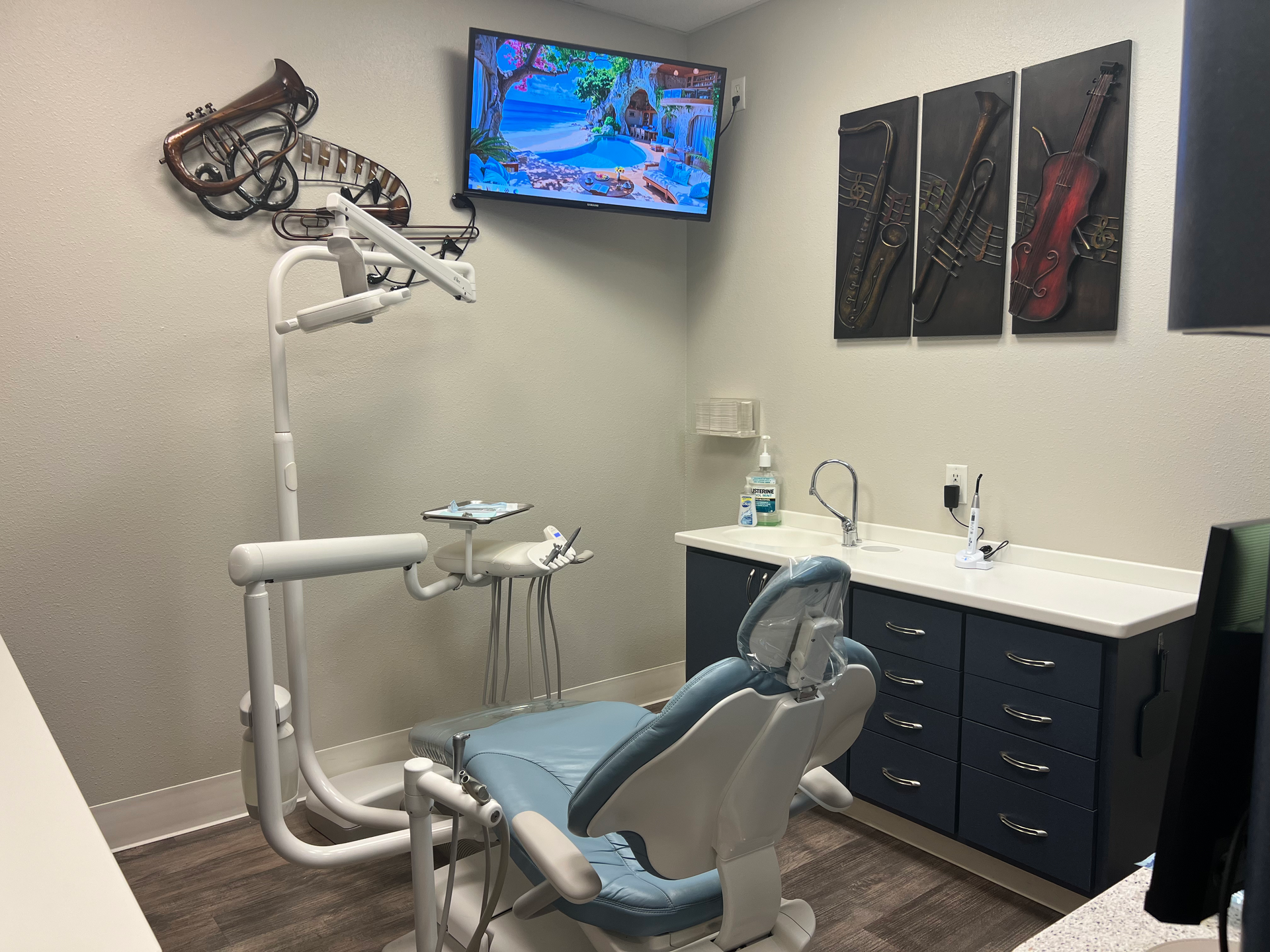 background image of a modern dental operatory with dental chair and equipment